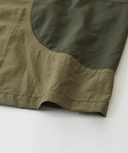 Japanese-style workwear with color blocking and large pockets, lightweight jacket.