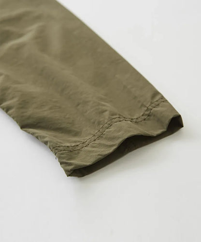 Japanese-style workwear with color blocking and large pockets, lightweight jacket.
